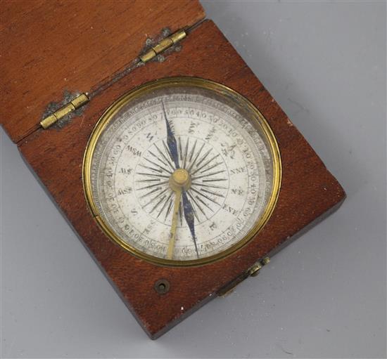 An early 19th century mahogany cased pocket compass, the dial marked in quadrants of ten degree divisions, the case 5cms sq.